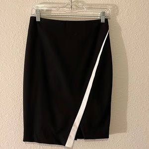 The limited pencil skirt with beautiful asymmetric flap across the front